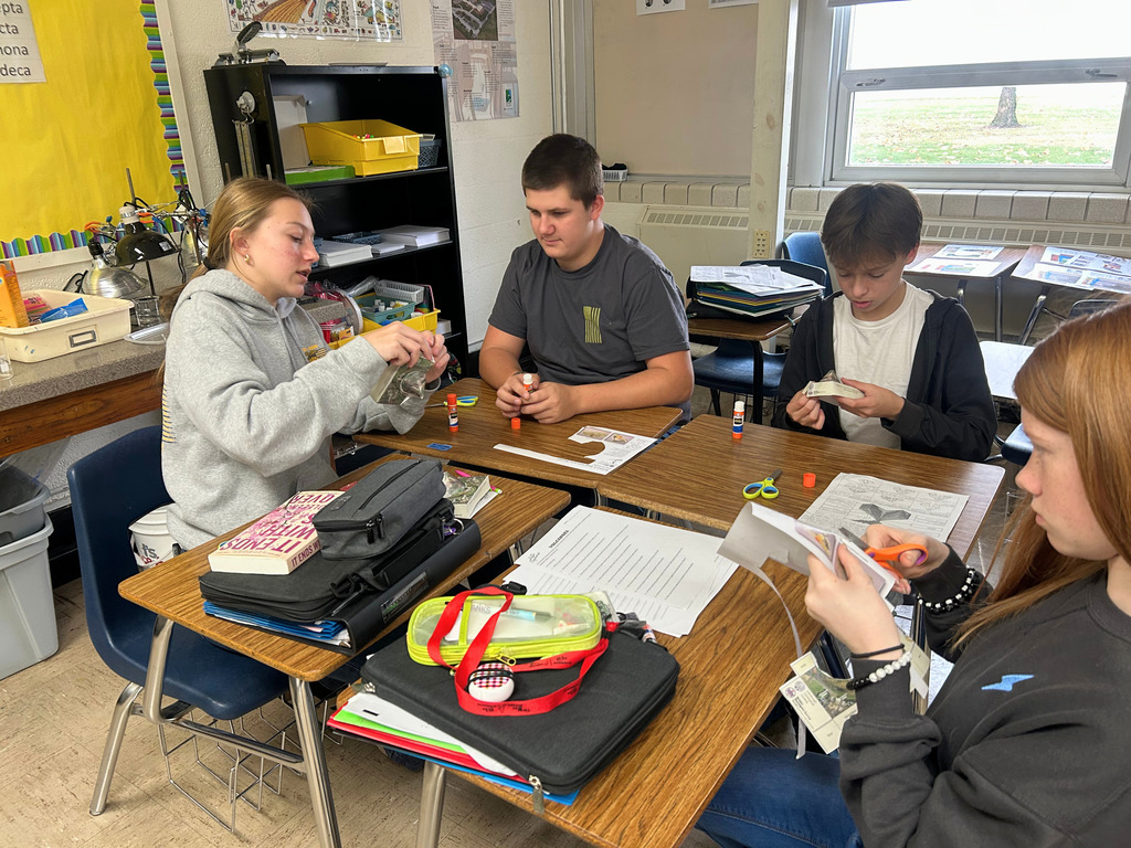 Students are working at their desks creating their volcanoes. 