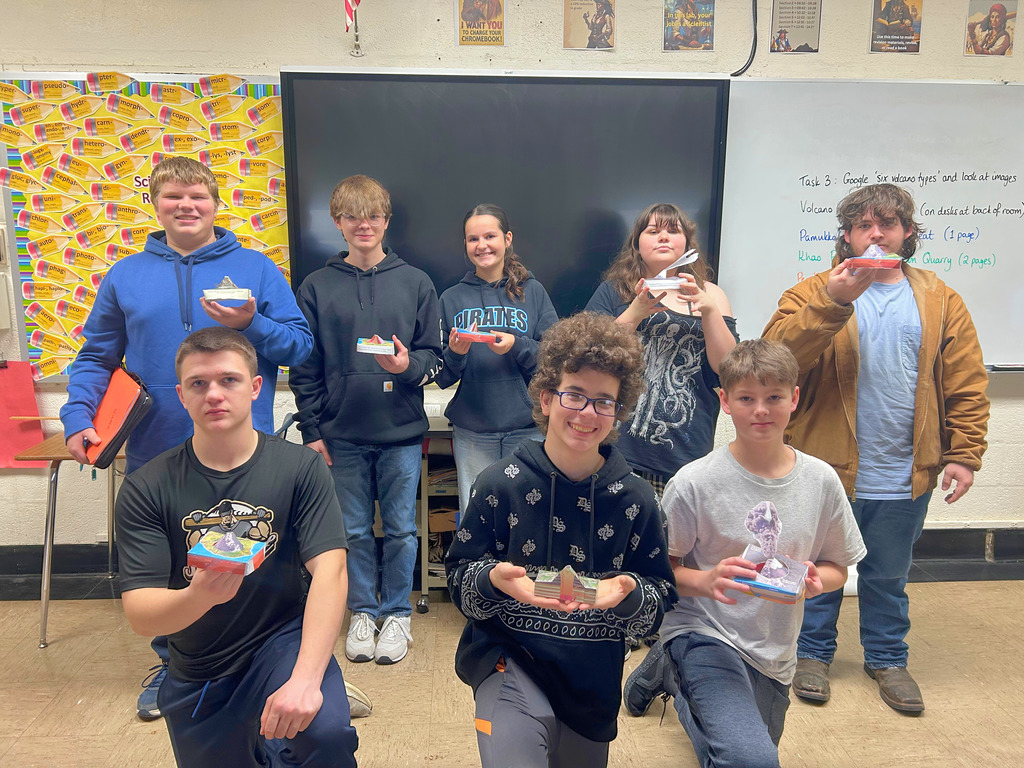 This is a group picture. Each student is holding their volcano. 