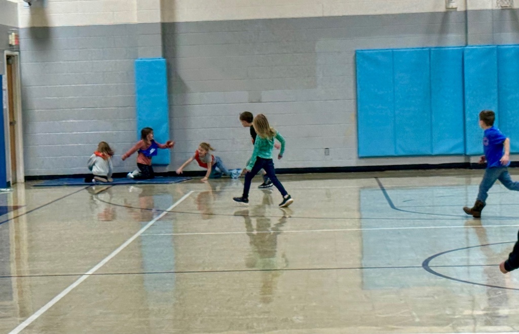 Students are running to a haystack, a mat in the corner of the gym. 