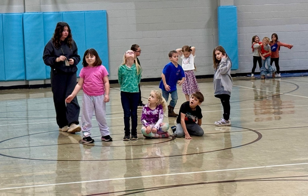 The hunters are waiting in the middle of the gym for a color to be called. 