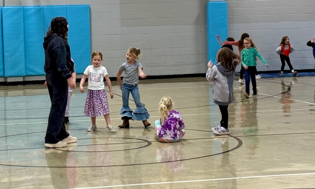 The hunters are waiting in the middle of the gym for a color to be called. 
