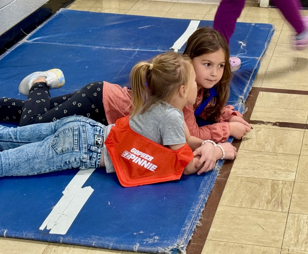 Two turkeys are resting on the haystack. 