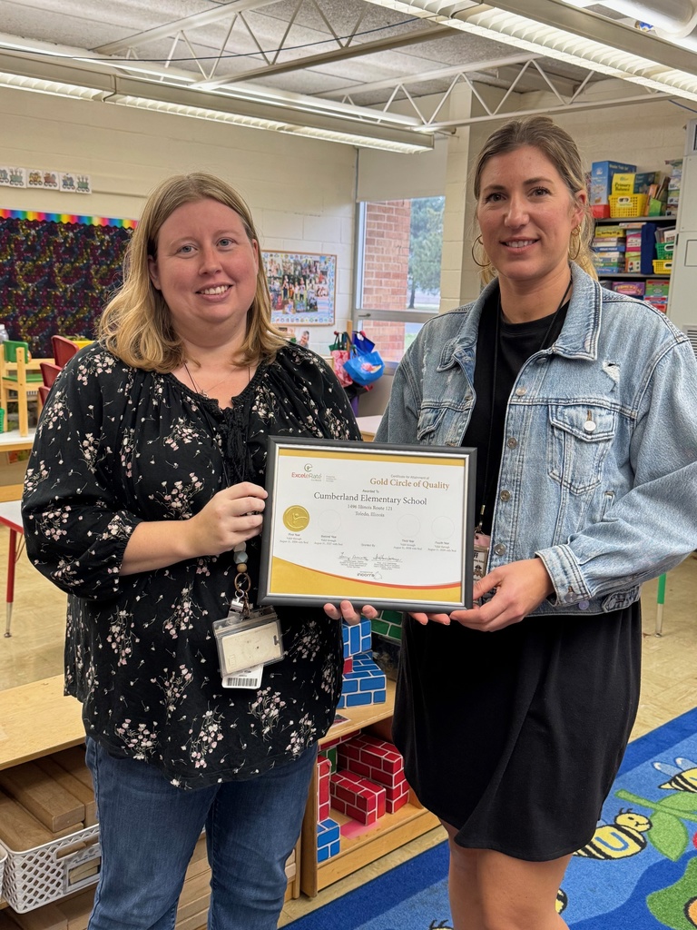 Pictured are the two early childhood teachers in a pre-school classroom. They are holding thecertificate with their gold circle. 