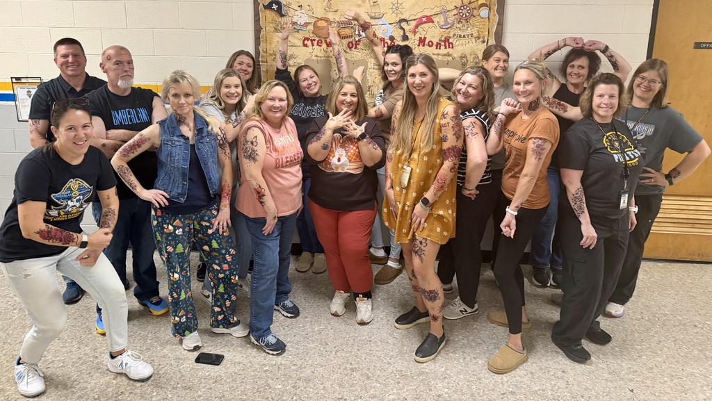 17 of the 18 staff members are displaying their temorary tattoos. 