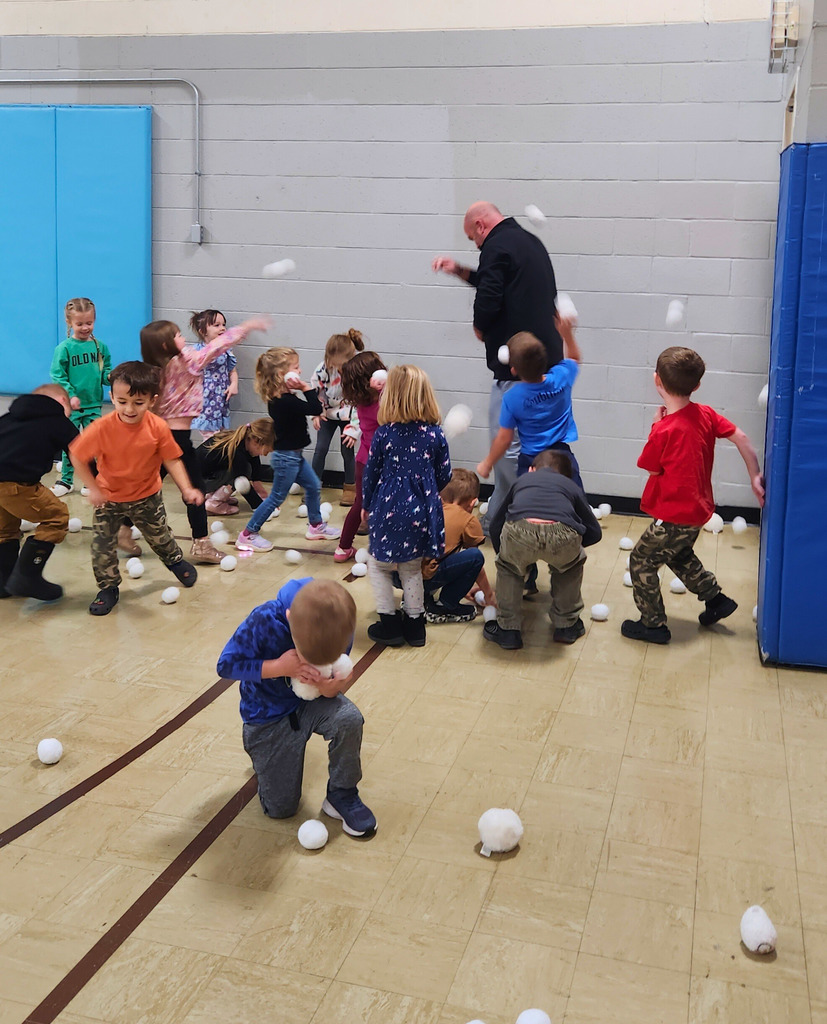 The preschool students are ganging up on Mr. Houchin and throwing "Snowballs" at him.Hes dodging and throwing them back.