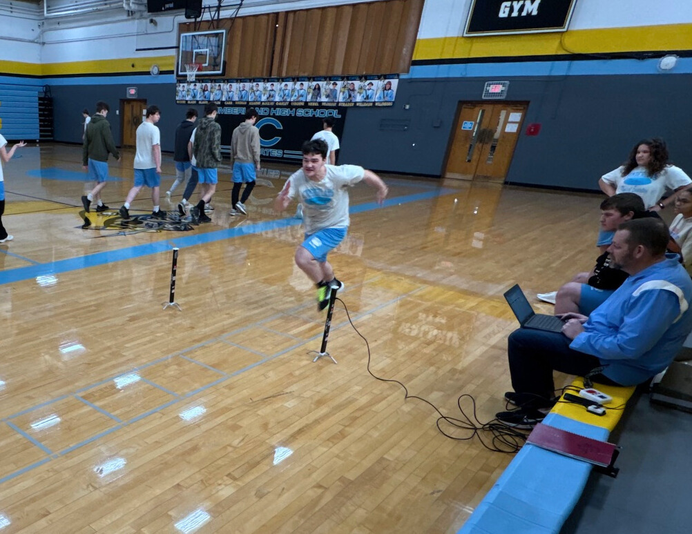 The student is running a portion of the shuttle run. The student is running between two sensors to one end of the run. 