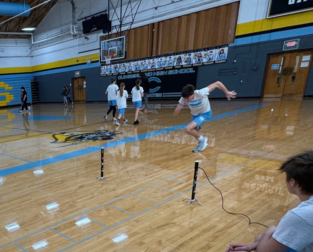 The student is running a portion of the shuttle run. The student is running between two sensors to one end of the run. 