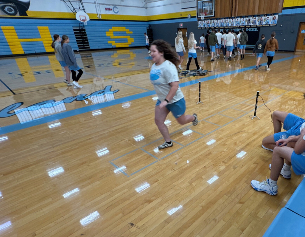 The student is running a portion of the shuttle run. The student is running between two sensors to one end of the run. 