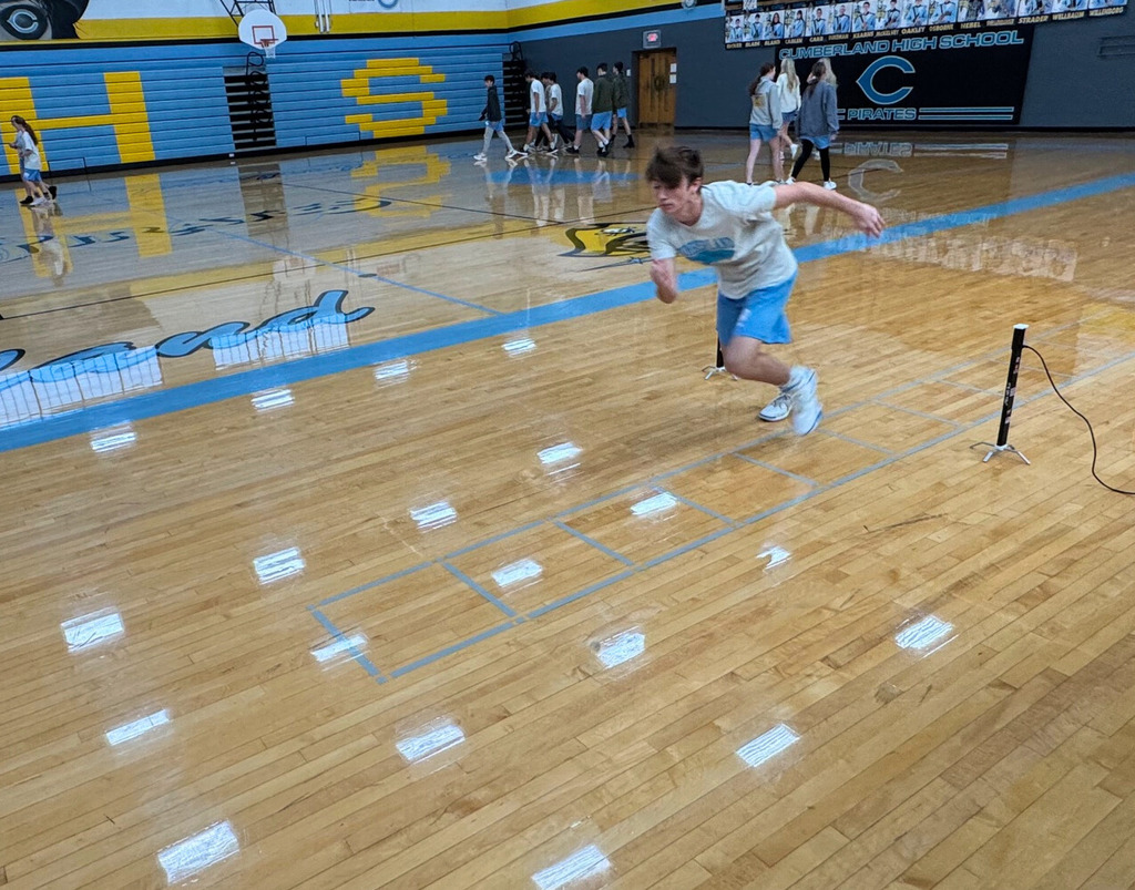 The student is running a portion of the shuttle run. The student is running between two sensors to one end of the run. 