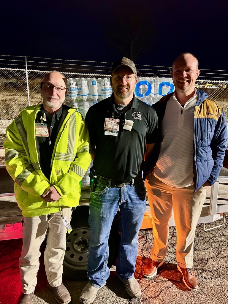 Pictured are Scott, Rob, and Preston Robinson standing in front of the water that Rural King donated. 