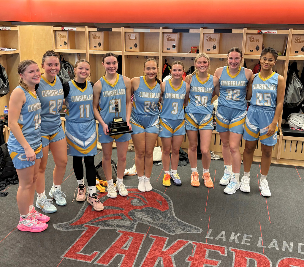 Pictured is the girls varsity team in the LLC locker room. The trophy is being held by one of the senior girls.