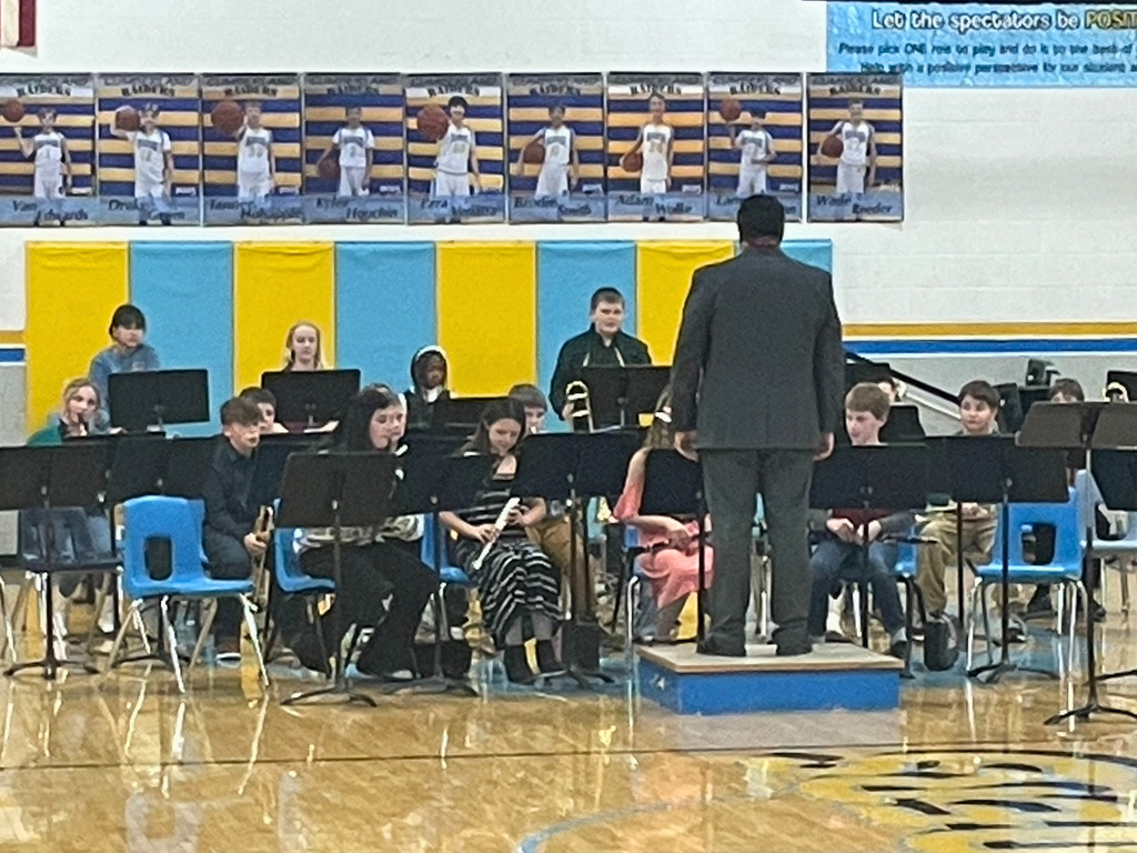 Pictured is the 5th grade band prior to their concert. They are sitting in their chairs ready to perform. 