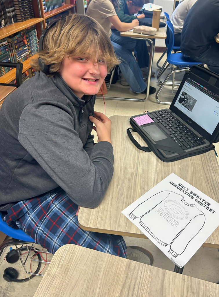 A student is sitting at his desk designing his sweater to look like the Green Bay Packers logo.