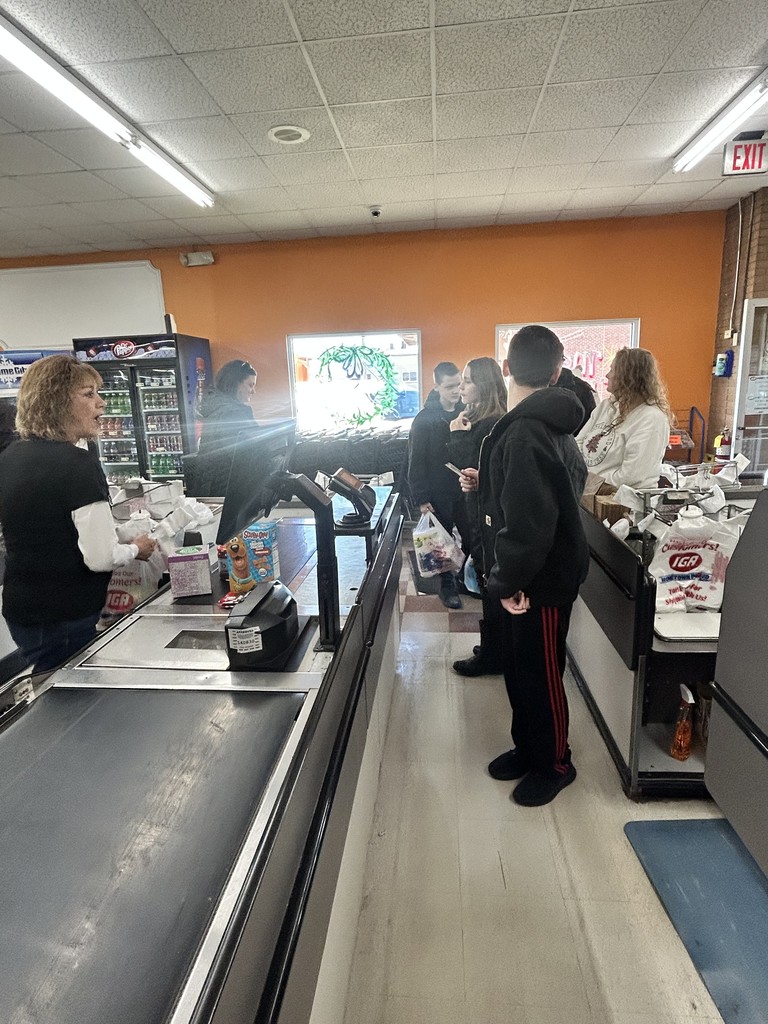 Students are checking out at the store. They are purchasing the items from their lists.