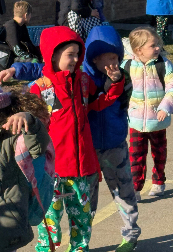 Students are waving to the visitors. 