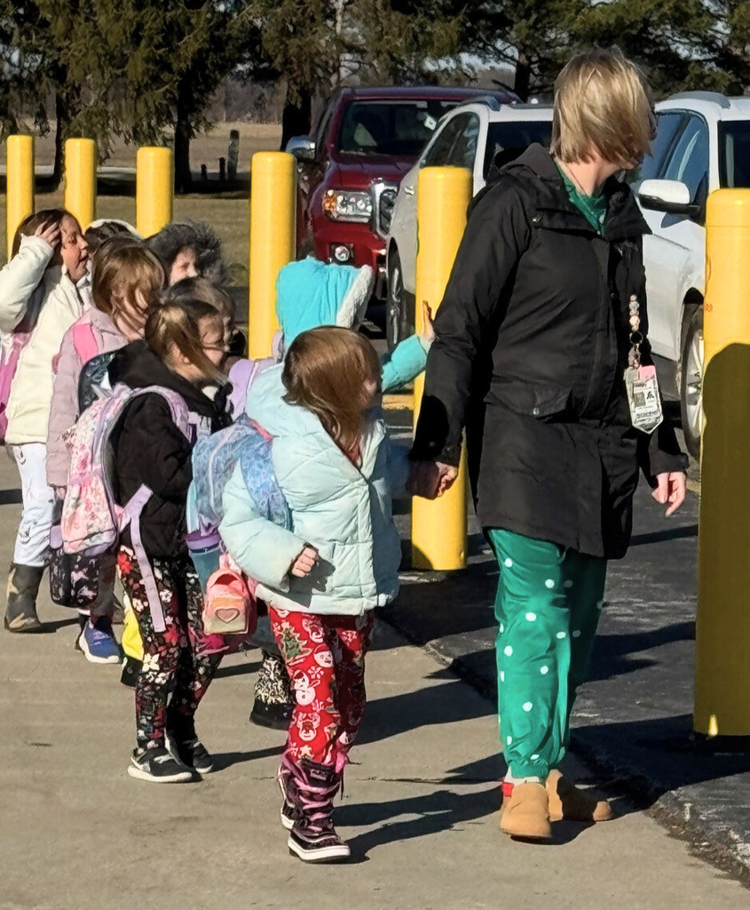 Students are waving to the visitors. 