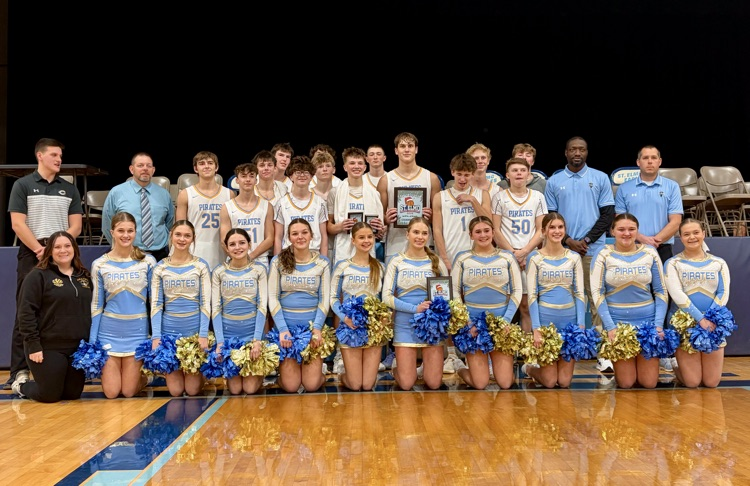 pictured are the boys, basketball team and the cheerleading team with all of the coaches. both teams are holding their trophies.