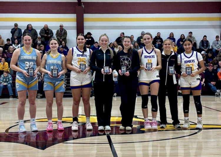 The all tournament team is standing at half court. The two Cumberland players are on the left side.