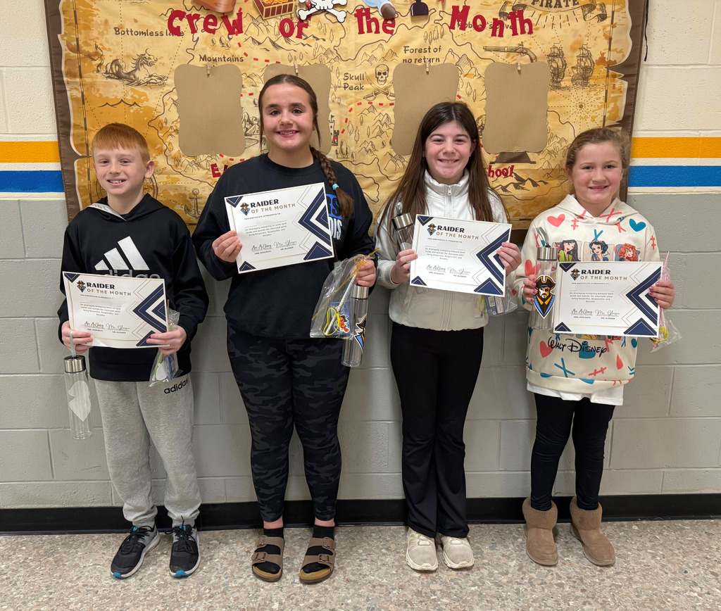 Pictured are the January Raiders of the Month. They are standing in front of the "Crew of the Month" bulletin board and holding their certificates and prizes.