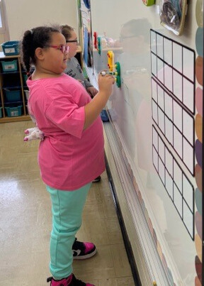 Two students are practicing math facts. They are using touchpoint numbers to help them figure out the answers.