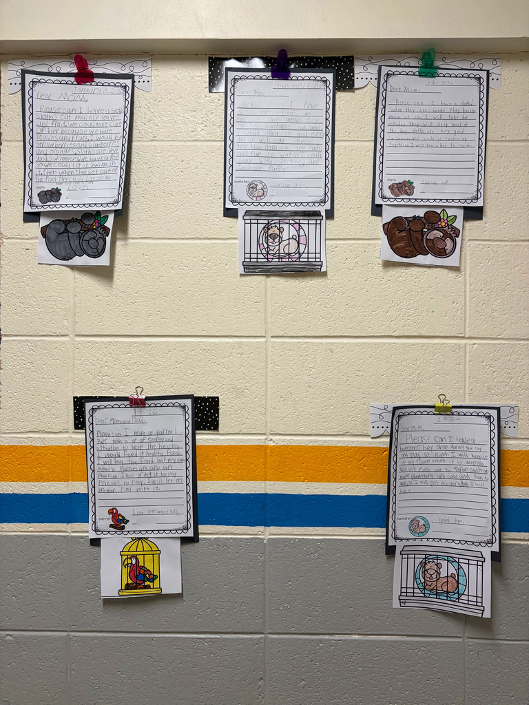 Five student letters are hung on the wall. They each have a picture of the pet they would like to have.