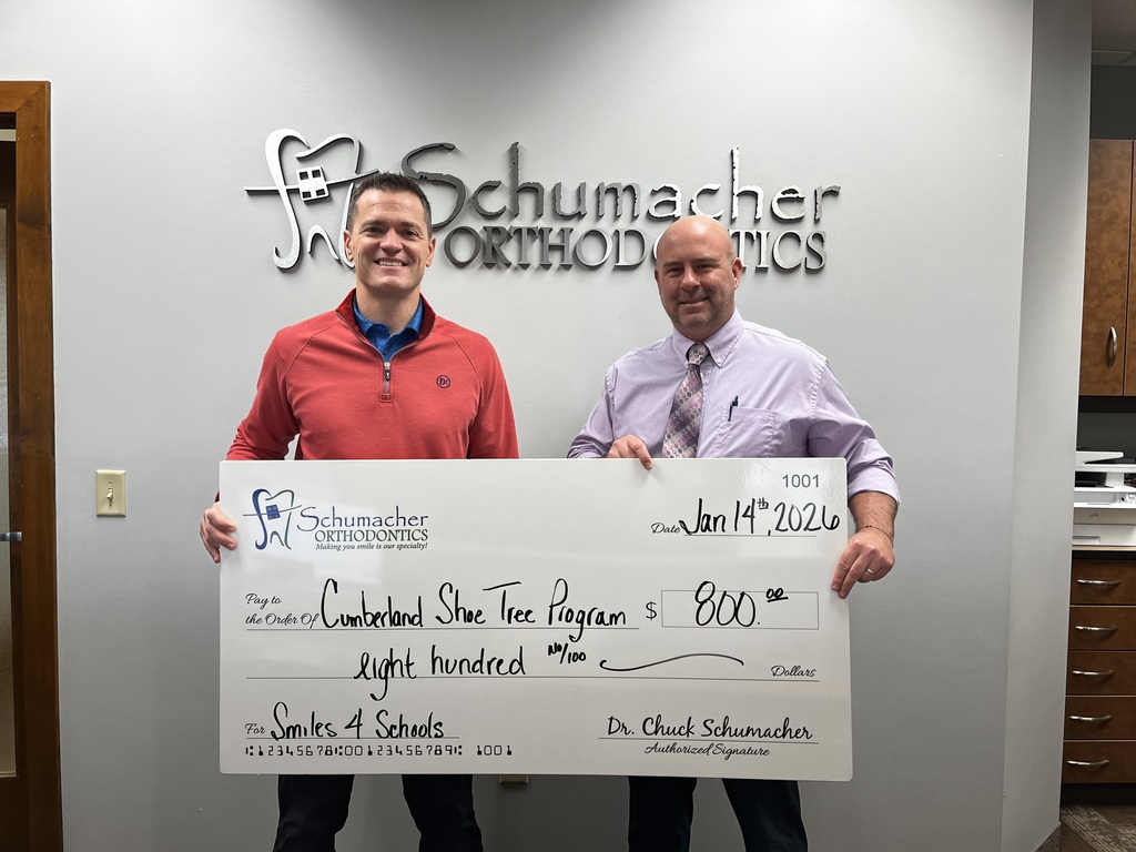 Pictured are Dr. Schumacher and Mr. Houchin. They are holding a large check for 800 written out to the Cumberland Shoe Tree Program. 