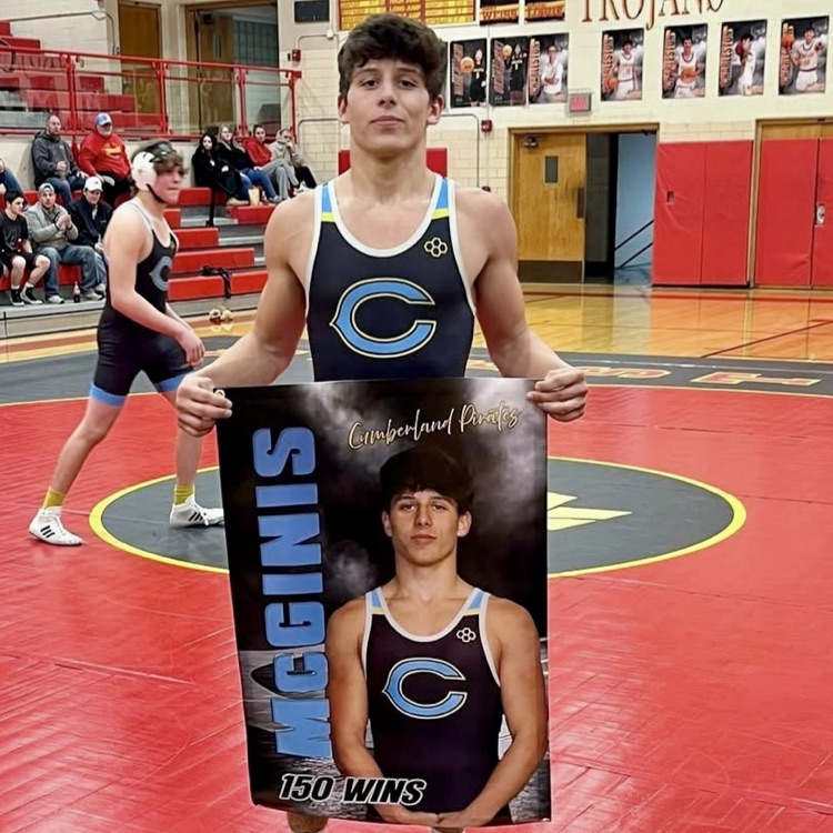 Pictured is OM holding his 150 wins banner at the wrestling match  