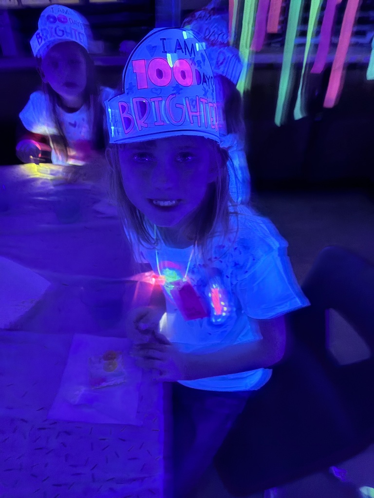 Students are sitting in the dark. They are eating a snack.