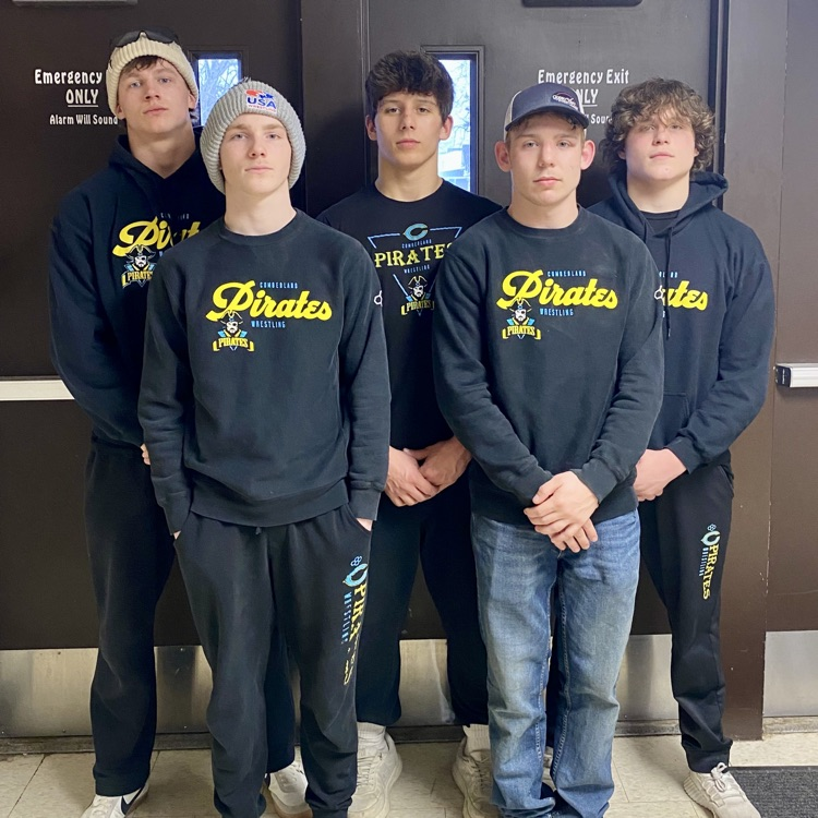 Pictured are the 5 boys mentioned in the post. the are standing together in front of doors  