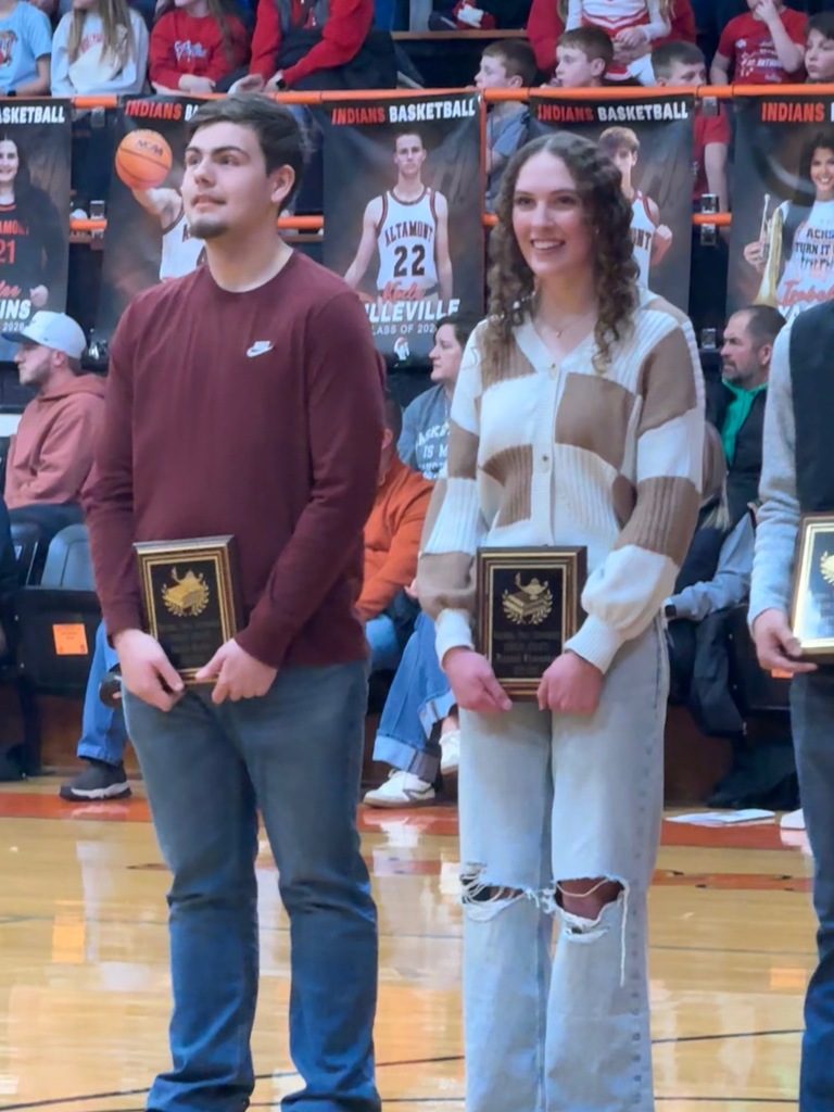 Pictured are HS and AB. Each are holding their plaque. 