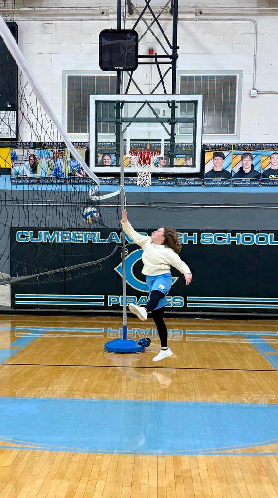 A student is spiking the volleyball into the net instead of to the opposite side of the court. 