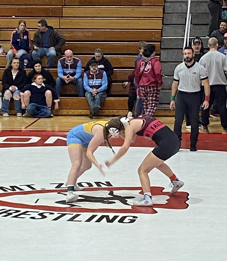 NB is standing with her opponent and they are locked head to head  