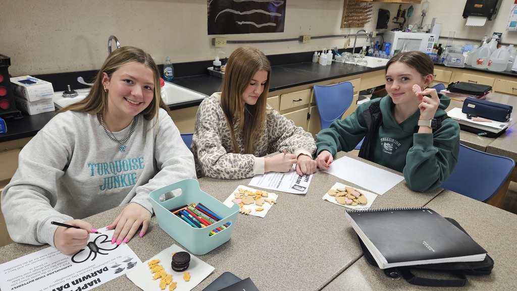 Students are coloring butterflies and eating animal snacks. 