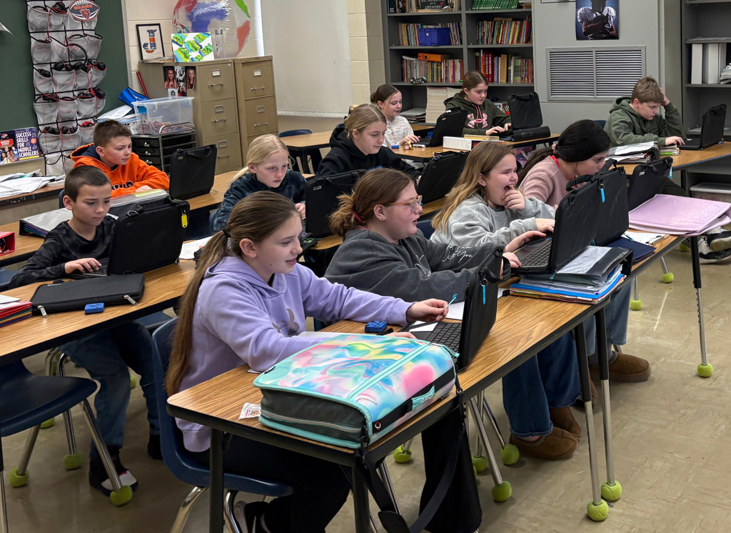 The students are sitting at their desks. They are playing GimKit on their Chromebooks. 
