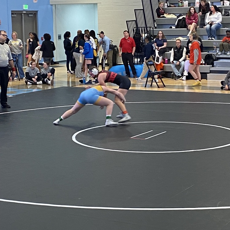 NB is going for the knees of her opponent on the black mat  