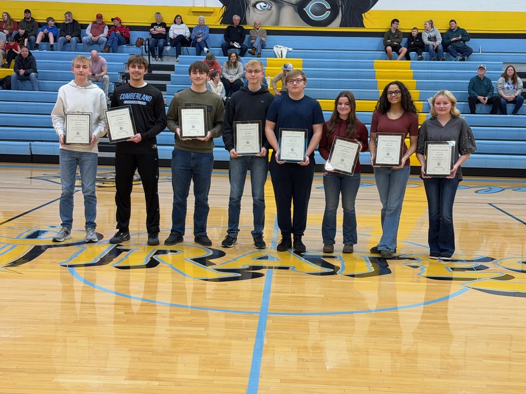 Pictured are the eight students awarded. They are standing side by side at center court. They are each holding their certificate. 