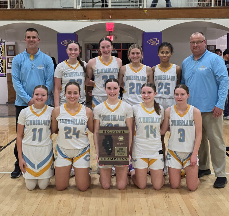 Pictured is the basketball team flanked by the two coaches. There are two rows. The player in the front center is holding the plaque. 