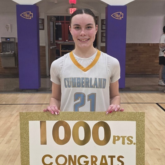 Pictured is JC holding a sign that says 1000 pts. Congrats Jade!