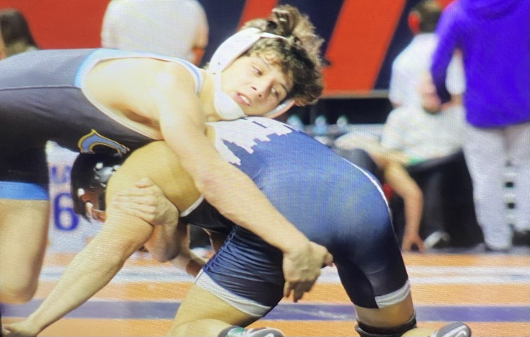 OM is on the back of the opponent. The opponent is on his arms and knees. Owen‘s head is wrestling on his back, trying to push him down.