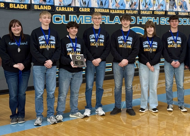 Picture is the CHS classical team standing side-by-side. Their coach is on the left. They are holding the team black.