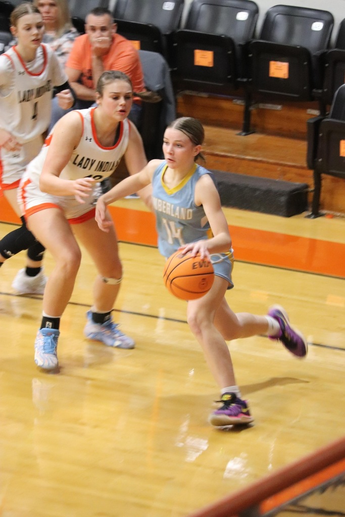 Pictured is JM driving the baseline past an Altamont player. She is dribbling with her left hand.