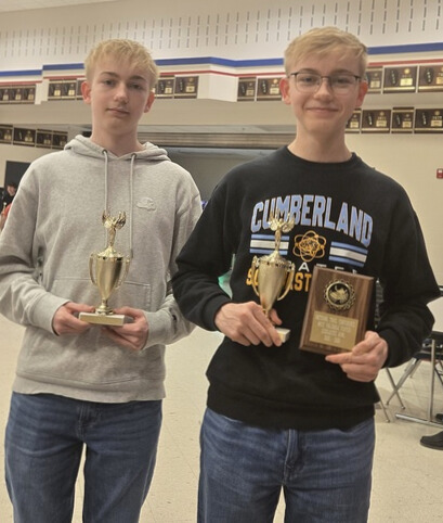 RJ and CJ are standing side by side. CH is holding a 1st team trophy and RJ is holding a trophy and the MVP plaque. 