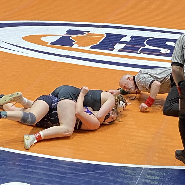 NB is on her opponent’s back maneuvering a pin. She is completing the pin 
