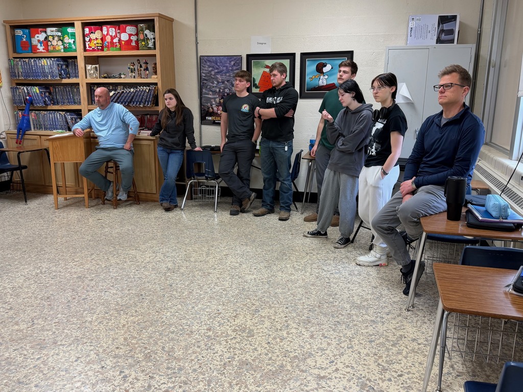 Two administrators and six students are standing at the disagree wall and listening to the other side explain their opinion. 
