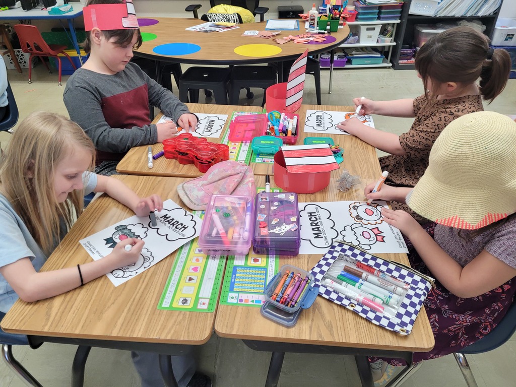 Four students are coloring their March in like a lion out like a lamb worksheets. 
