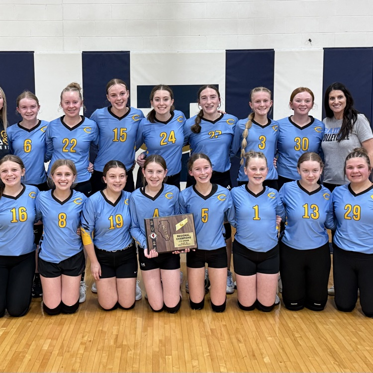 This is a team picture. There are two rows. The individuals in the first row are holding the championship plaque. 