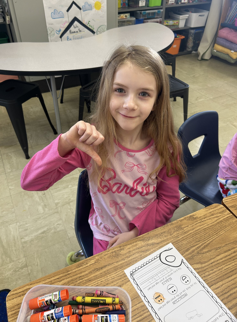 A student is giving the thumbs down sign. 