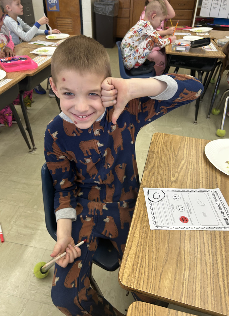 A student is giving the thumbs down sign. 