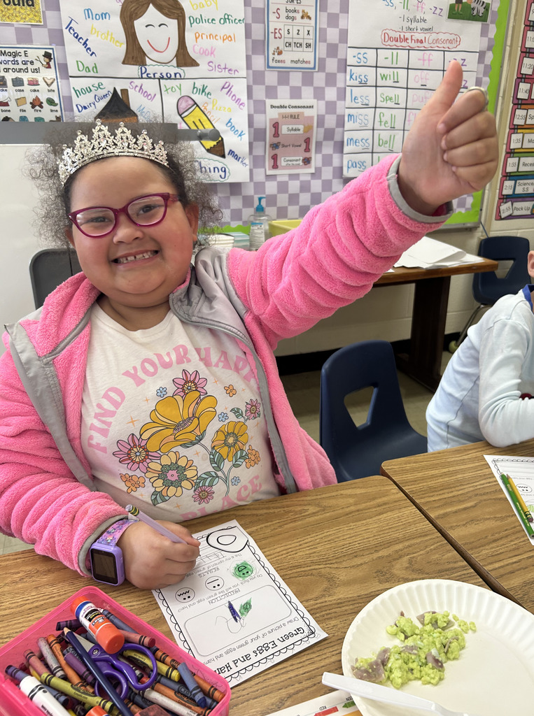 A student is giving the thumbs up sign. 