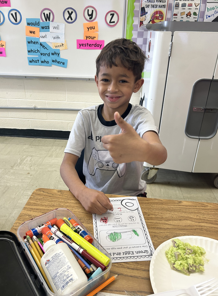 A student is giving the thumbs up sign. 